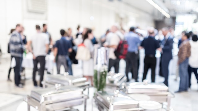 A group of employees conversing in a corporate lobby