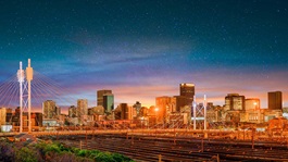 View of city skyline and stars at night