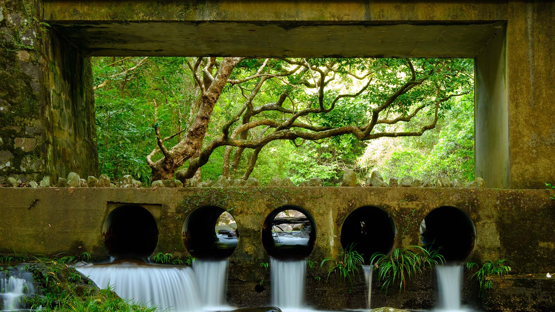 Water draining under a scenic bridge