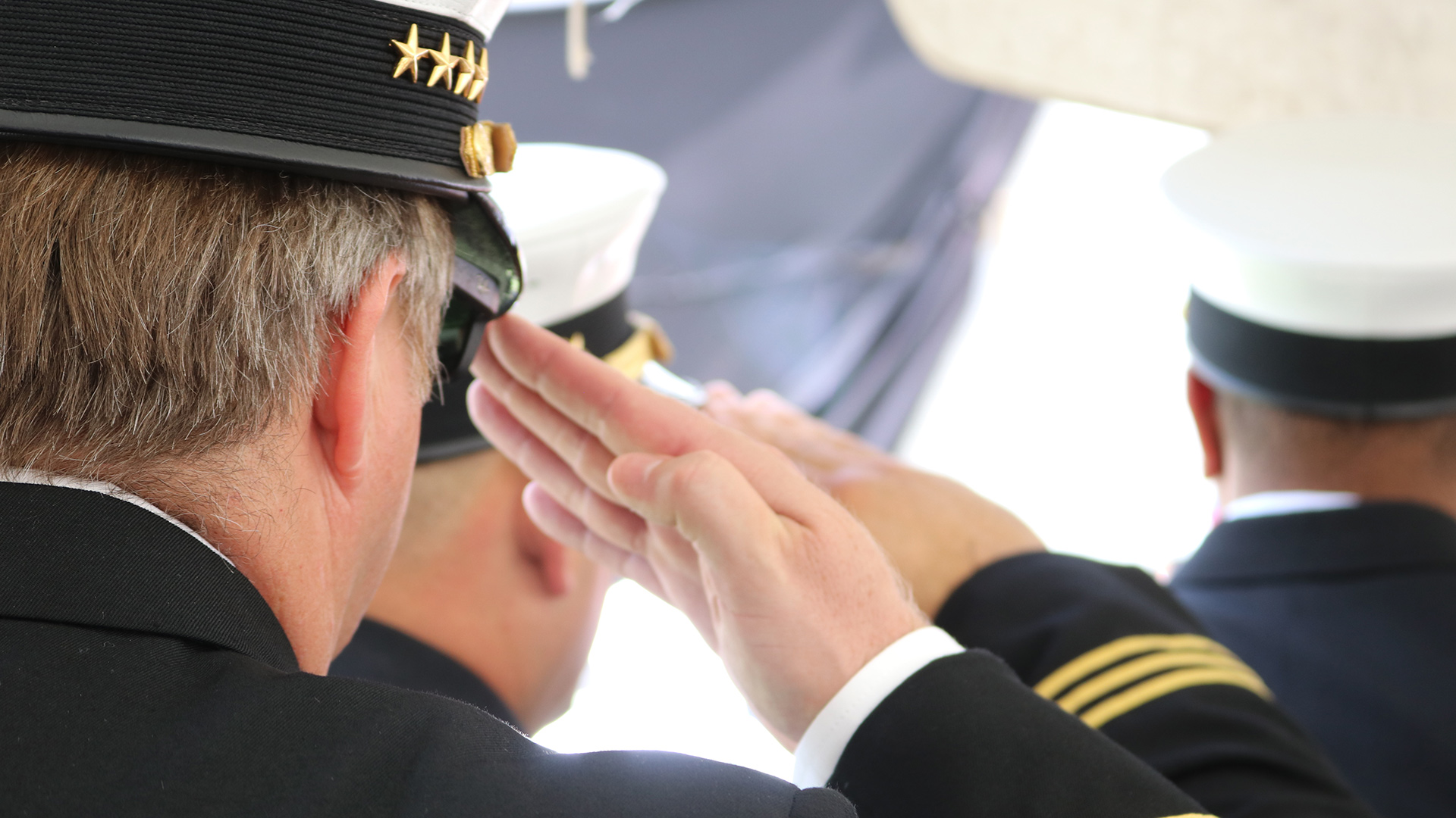 Military members saluting Military members saluting