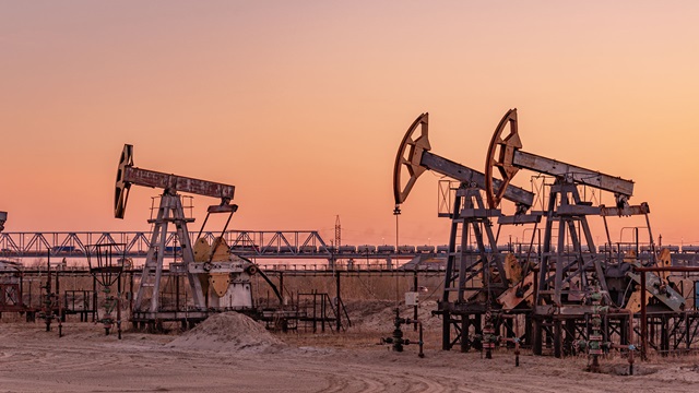 Oil derricks in desert landscape