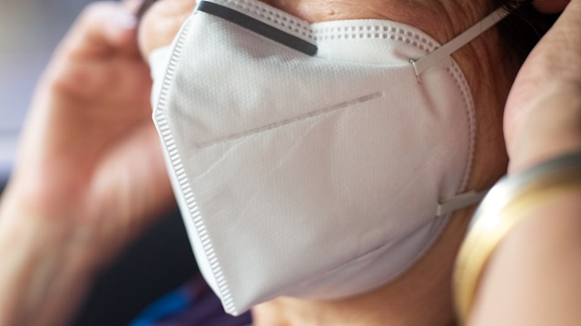 Person putting on mask